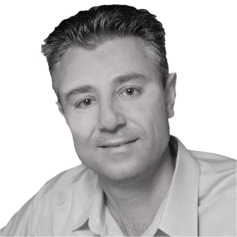 Black and white headshot of a man with short hair wearing a collared shirt.